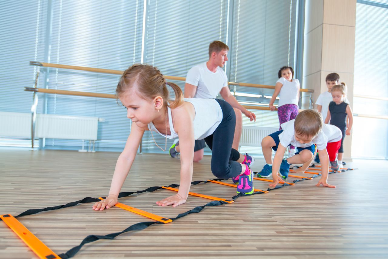 Happy sporty children in gym. Kids exercises