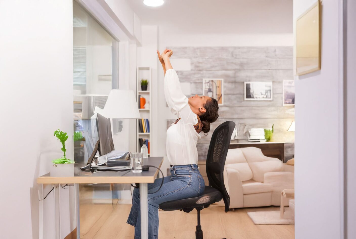 fatigued-woman-stretching-her-back-while-working-laptop-from-home-office-ai-erweitert